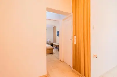a hallway with a yellow column in a room at Sefis apartment in Athens