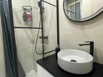 a bathroom with a white sink and a mirror at Chris375flat-ParkOperaOnasioRea in Athens