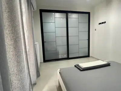 a room with a bed and a large window at Chris375flat-ParkOperaOnasioRea in Athens