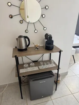 a table with a mirror on a wall at Sparrow s nest in Koropíon