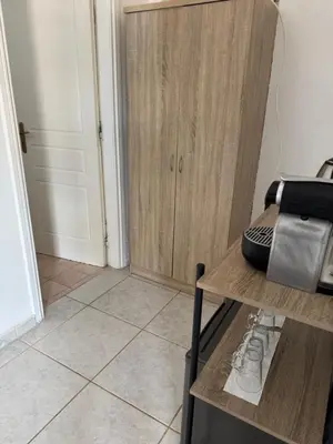 a room with a wooden cabinet and a table at Sparrow s nest in Koropíon