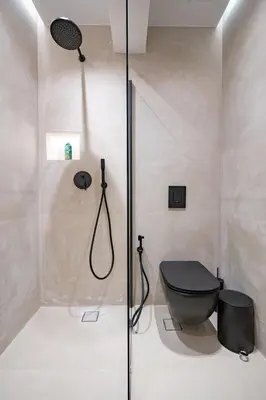 a bathroom with a shower with a black toilet at Glyfada Lux Olive Suites - Aura & Glow in Athens