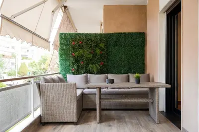a patio with a table and chairs on a balcony at Glyfada Lux Olive Suites - Aura & Glow in Athens