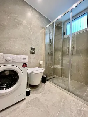 a washing machine in a bathroom with a shower at Home in Piraeus in Piraeus