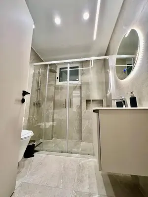 a bathroom with a shower with a toilet and a sink at Home in Piraeus in Piraeus