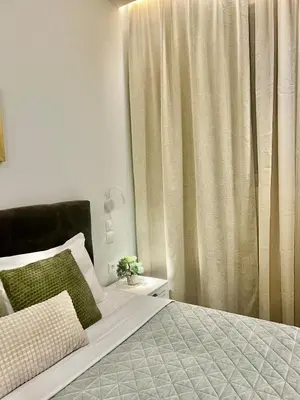 a bedroom with a bed and a window with curtains at Home in Piraeus in Piraeus