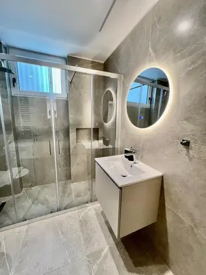 a bathroom with a sink and a shower at Home in Piraeus in Piraeus