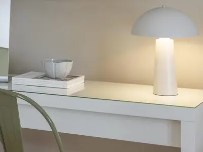 a white table with a lamp and books on it at Pause In Athens in Athens