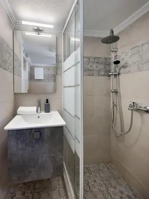 a bathroom with a sink and a shower at Pause In Athens in Athens