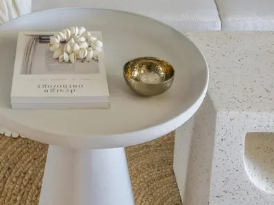 a table with a book and a bowl of flowers on it at Pause In Athens in Athens