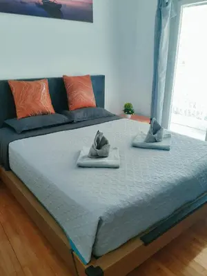a large bed with two hats on top of it at \u96c5\u5178\u6d77\u6ee8\u516c\u5bd3 in Athens