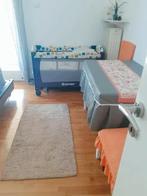 a hospital room with a bed and two rugs at \u96c5\u5178\u6d77\u6ee8\u516c\u5bd3 in Athens
