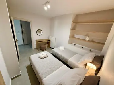 a hotel room with two beds and a desk at Christina's Home in Athens