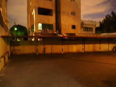 an empty parking lot in front of a building at Aegli Hotel in Athens