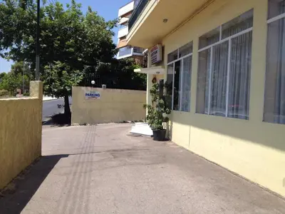 an empty sidewalk next to a building with a window at Aegli Hotel in Athens