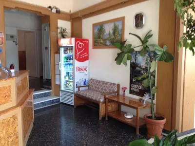 a coffee shop with a couch and a table at Aegli Hotel in Athens