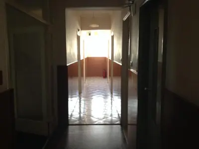an empty hallway with a door leading to a room at Aegli Hotel in Athens