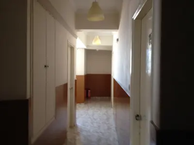 an empty hallway with a hallway leading to a room at Aegli Hotel in Athens