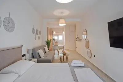 a living room with a bed and a couch at Silia Spotless Fully Renovated Studio in Athens