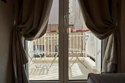 a sliding glass door with a view of a balcony at Silia Spotless Fully Renovated Studio in Athens