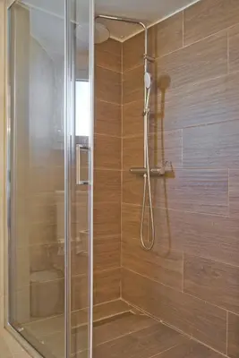 a shower with a glass door in a bathroom at Silia Spotless Fully Renovated Studio in Athens