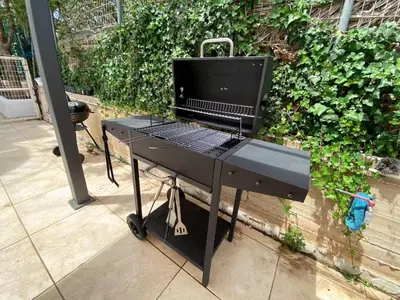 a bbq grill with a computer on top of it at Versailles One Garden Villa Full Floor Suite in Koropíon