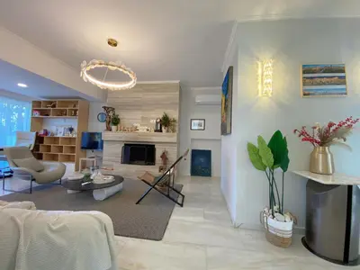 a living room with a couch and a fireplace at Versailles One Garden Villa Full Floor Suite in Koropíon