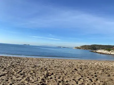 a sandy beach with a view of the ocean at Versailles One Garden Villa Full Floor Suite in Koropíon