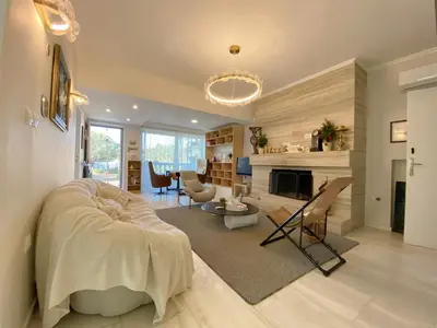 a living room with a couch and a fireplace at Versailles One Garden Villa Full Floor Suite in Koropíon