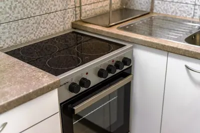 a kitchen with a stove and a sink at Glyfada Muse - Sea and City Apartment in Athens