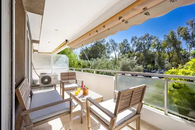 a balcony with two chairs and a table with a view at Glyfada Muse - Sea and City Apartment in Athens