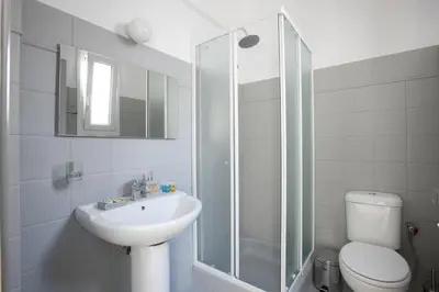 a bathroom with a toilet and a sink and a shower at Ano Patisia, A 5th Floor Fully Renovated Penthouse in Athens