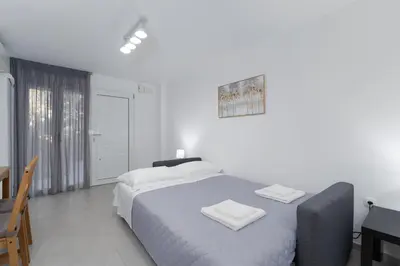 a bedroom with a bed with two towels on it at Maria's Garden in Athens