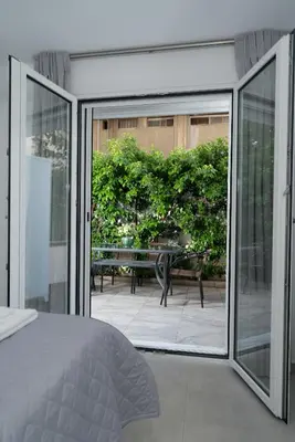 a bedroom with sliding glass doors leading to a patio at Maria's Garden in Athens