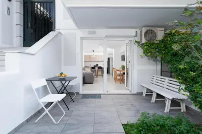 a patio with a bench and a table at Maria's Garden in Athens