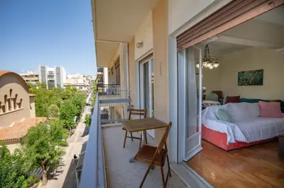 a balcony with a bed and a view of a city at Athens Central Charm by ΜΡS in Athens
