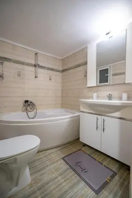 a bathroom with a tub and a toilet and a sink at Athens Central Charm by ΜΡS in Athens