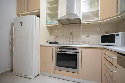 a kitchen with a white refrigerator and a microwave at Athens Central Charm by ΜΡS in Athens