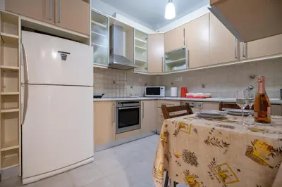 a kitchen with a white refrigerator and a table at Athens Central Charm by ΜΡS in Athens