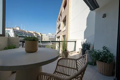a patio with a table and chairs on a balcony at Athens Central Skyline Studio by ΜΡS in Athens