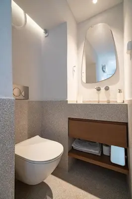 a bathroom with a toilet and a mirror at Athens Central Skyline Studio by ΜΡS in Athens