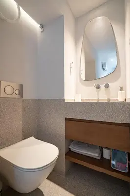 a bathroom with a white toilet and a mirror at Athens Central Skyline Studio by ΜΡS in Athens