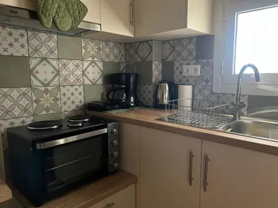 a small kitchen with a stove and a sink at Athenian Loft with urban view! in Athens