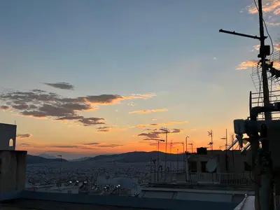a view of the sunset from a ship at Athenian Loft with urban view! in Athens