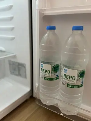 two bottles of water in an open refrigerator at Athenian Loft with urban view! in Athens