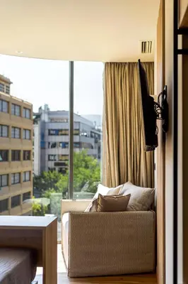 a living room with a couch and a large window at Bliss Luxury Apartments in Athens