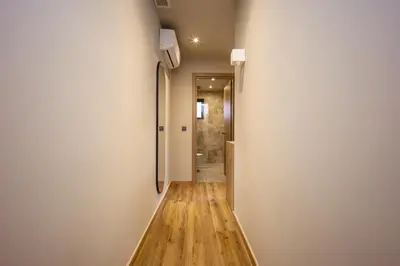 a hallway leading to a bathroom with a shower at Bliss Luxury Apartments in Athens