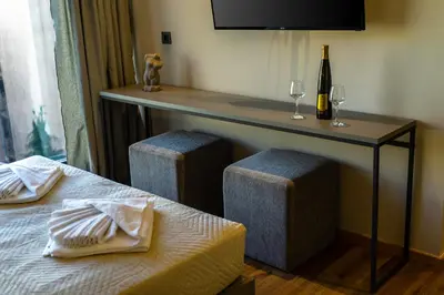 a room with a table and two beds and a bottle of wine at Bliss Luxury Apartments in Athens