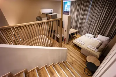 a small room with a bed and a staircase at Bliss Luxury Apartments in Athens