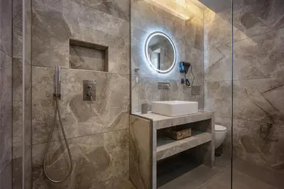a bathroom with a shower and a sink and a toilet at Bliss Luxury Apartments in Athens